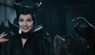 Maleficent Angelina Jolie smiles with her raven on hand