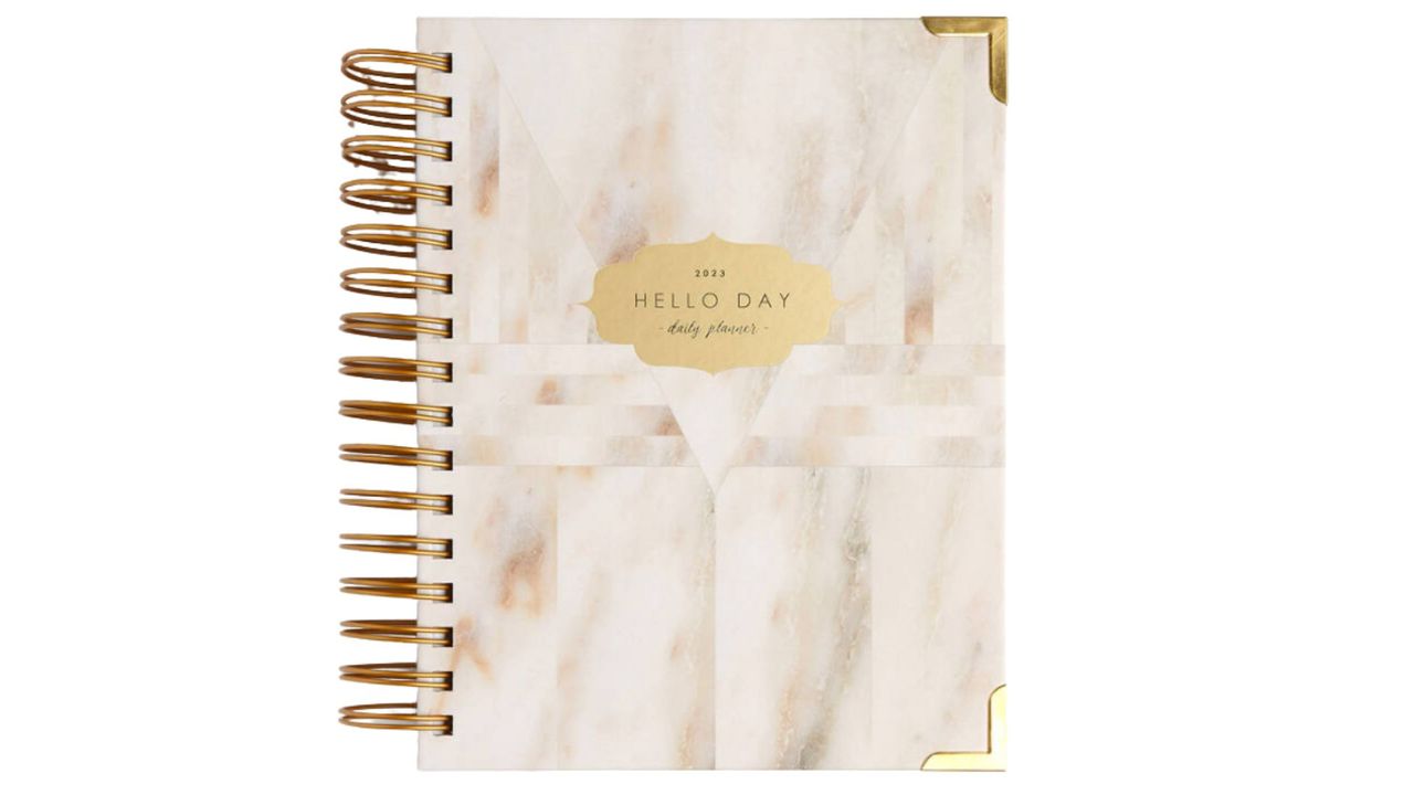 A marble design planner with a spiral bound.
