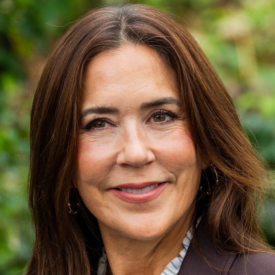 Queen Mary smiling in a brown blazer
