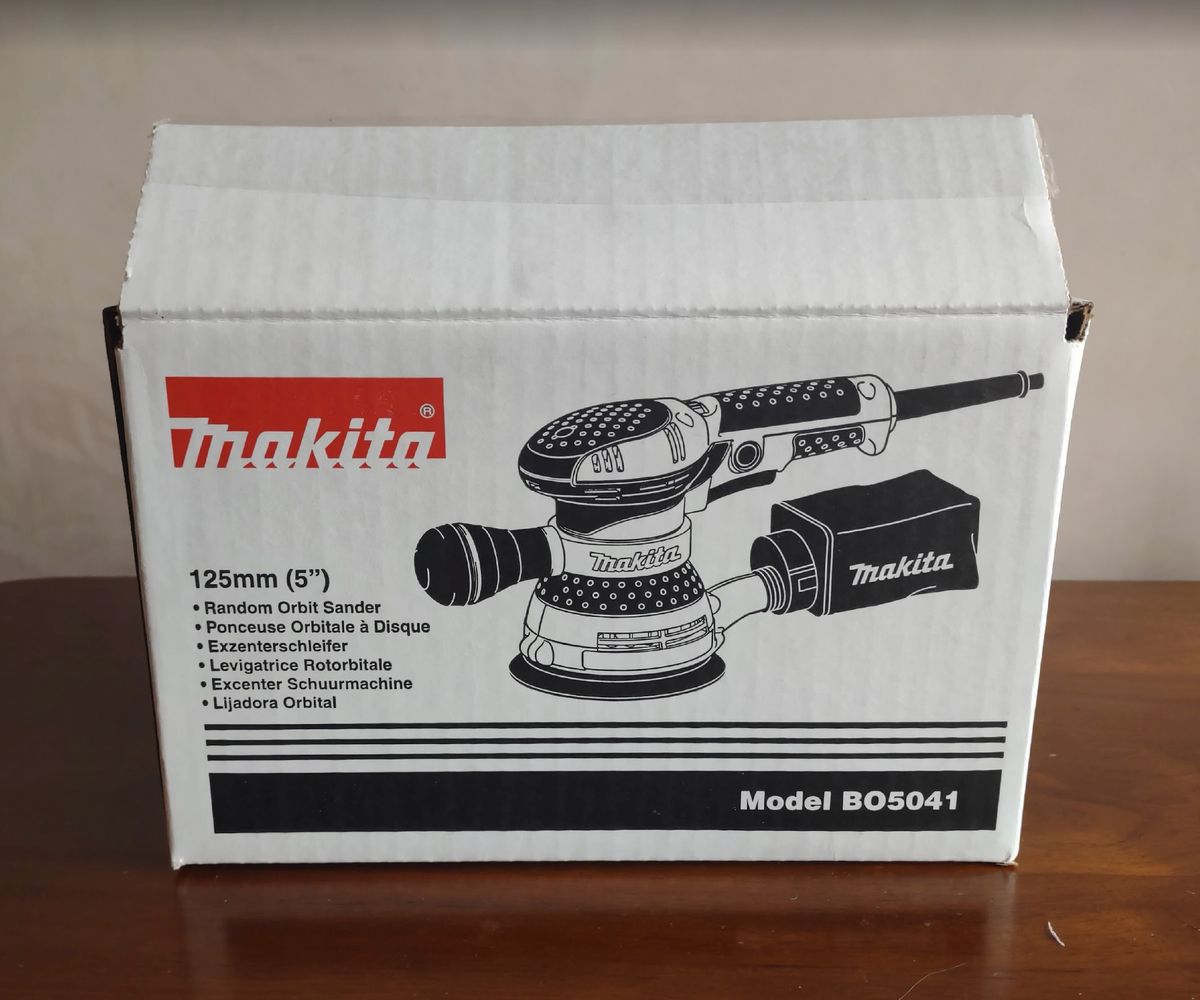 The packaging for a Makita BO5041 Random Orbit Sander