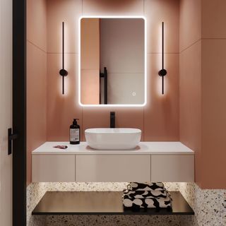 bathroom with pink wall white wash basin and mirror with led light frame