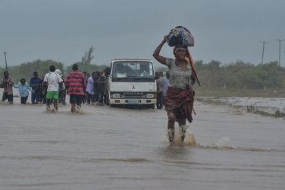 A woman braves flood waters in Mozambique.