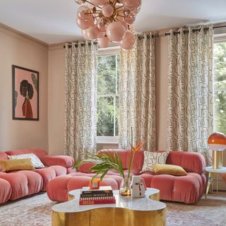 peach sofas in a pink living room, brass coffee table