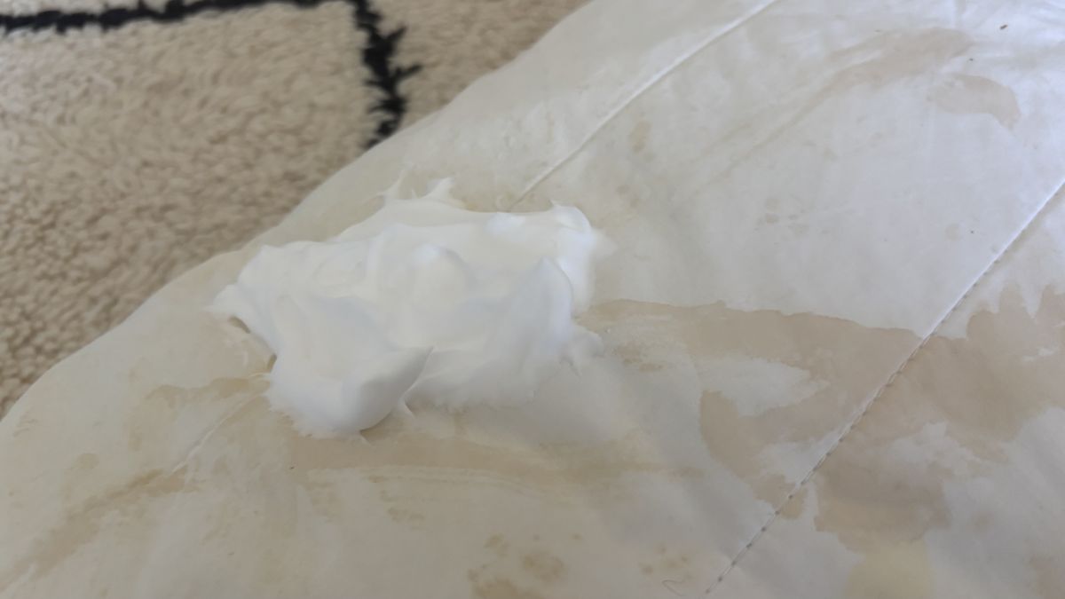 A dollop of shaving foam on a pillow stain.