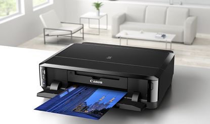 The best printers hero image showing a Canon printer printing a photograph