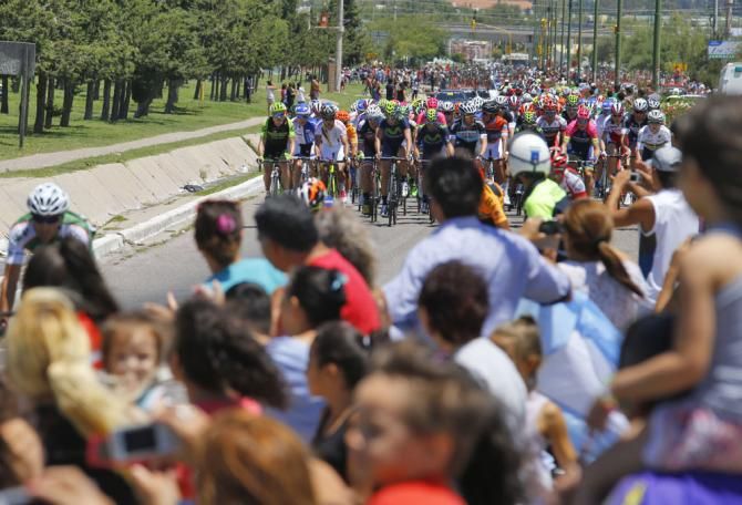 The fans cheer on the riders as they go past
