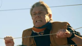 Johnny Knoxville grabbing an electric fence in Tiny Fugitives