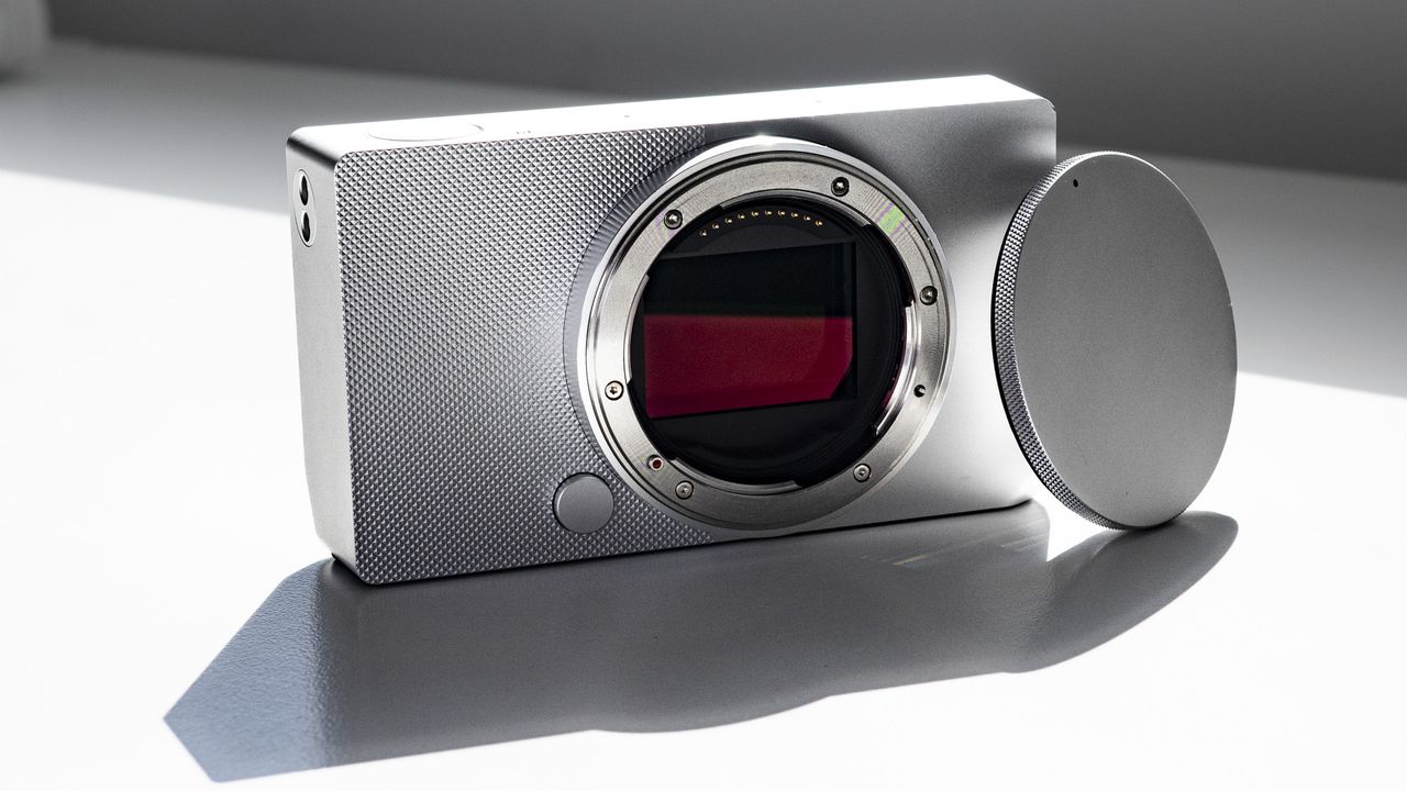 Sigma BF with its body cap, on a white surface in strong light, with defined shadows