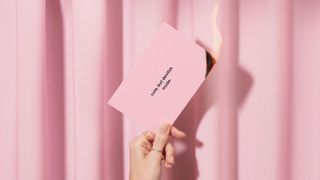 pink business card on fire