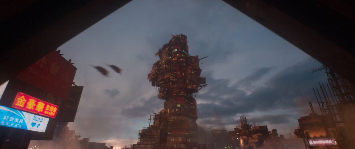 Babiru DaVinci Resolve tips; A large, complex, and imposing structure dominates the urban landscape under a cloudy sky.