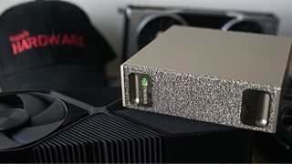 A DGX Spark sitting on top of a graphics card.