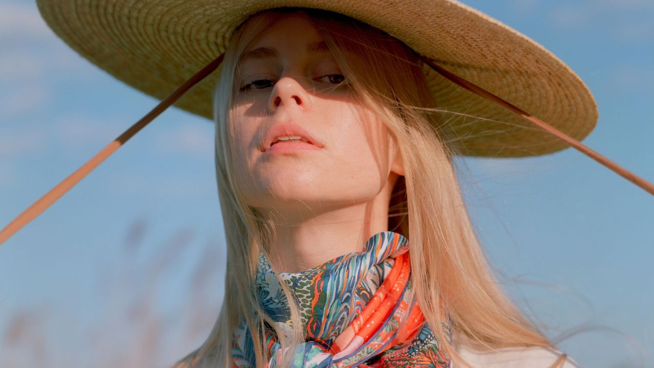 Woman wearing a hat in a meadow