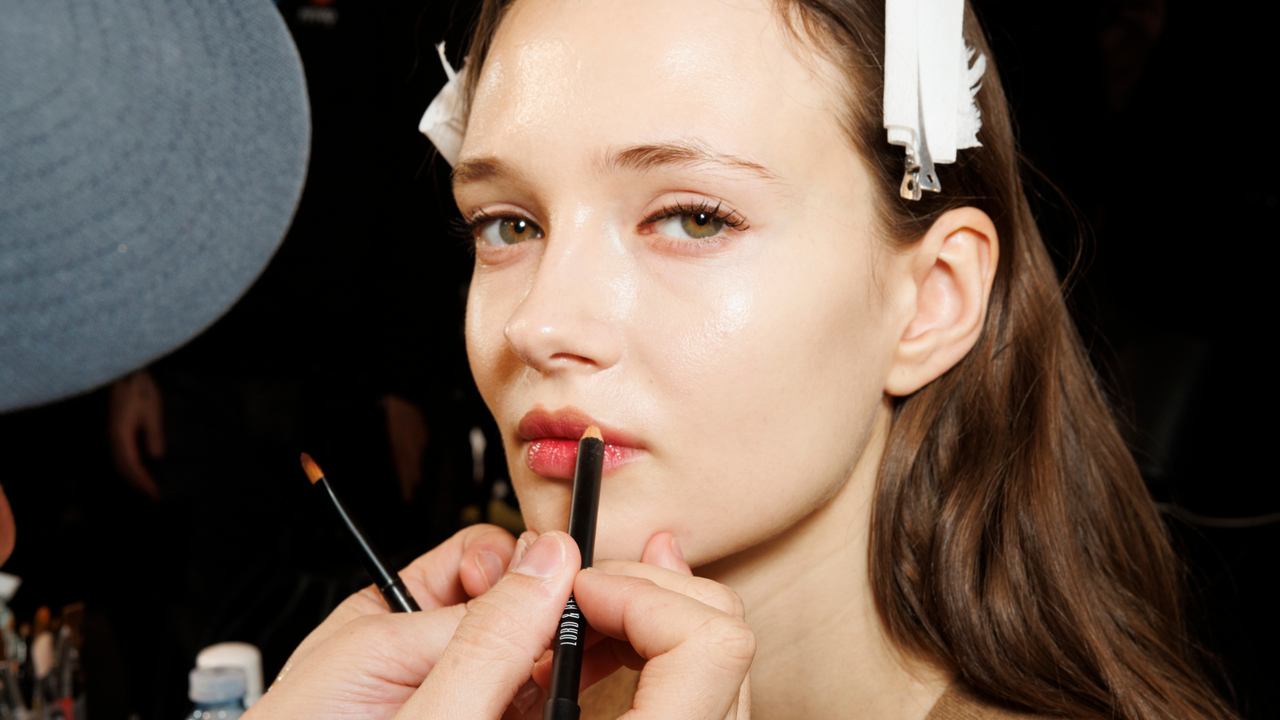 Woman having make-up applied at MFW 