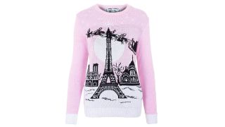 British Christmas Jumpers illustrated by a recycled jumper featuring Santa flying over the Eiffel Tower