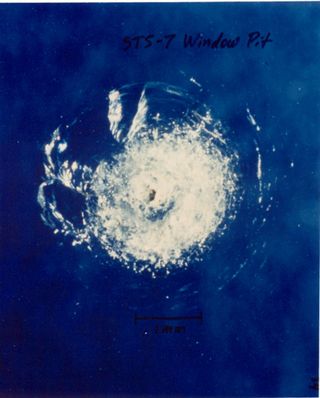 Window pit from orbital debris on Challenger's STS-7 mission in June 1983.