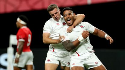 Manu Tuilagi celebrates his second try against Tonga with England team-mate George Ford 