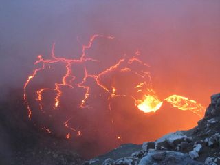 Lava flows off a small cliff and into a lava lake May 11, 2011 on Hawaii's Kilauea Volcano.