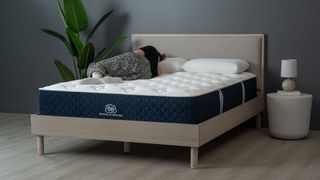 Brooklyn Bedding Signature Hybrid mattress with Tom's Guide Sleep Editor lying on it is the best budget pillow-top mattress