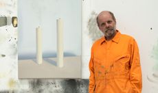 Portrait of Gavin Turk with his Kerze candle painting in the artists London studio