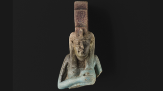 A glazed ceramic statuette of Isis suckling her son Horus from ancient Egypt.