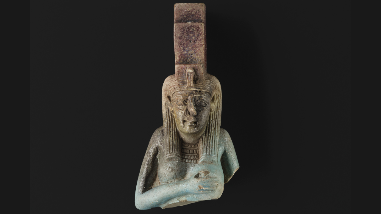 A glazed ceramic statuette of Isis suckling her son Horus from ancient Egypt.