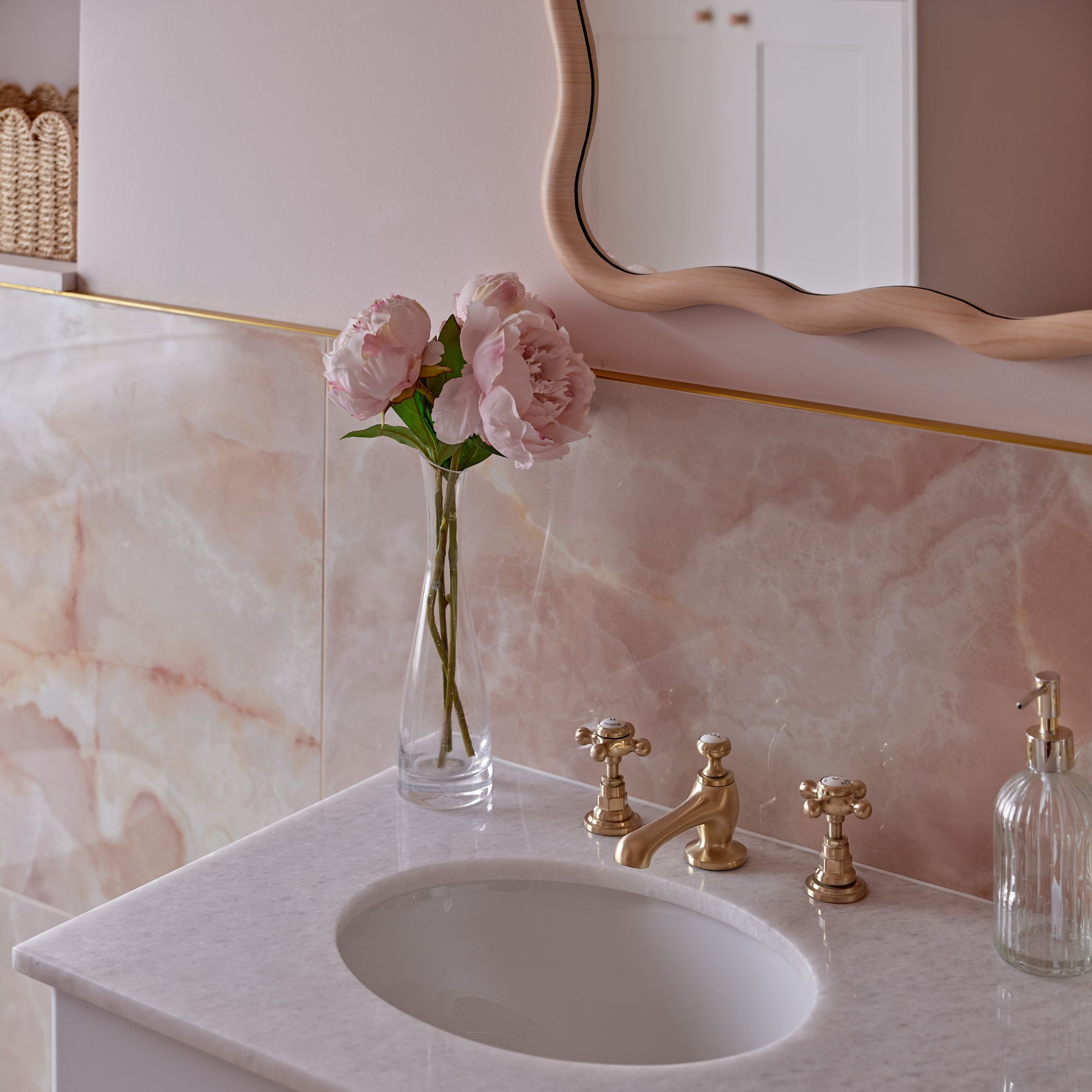 Pink onyx wall behind a bathroom sink