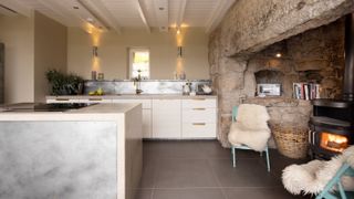 modern kitchen with traditional stone inglenook fireplace