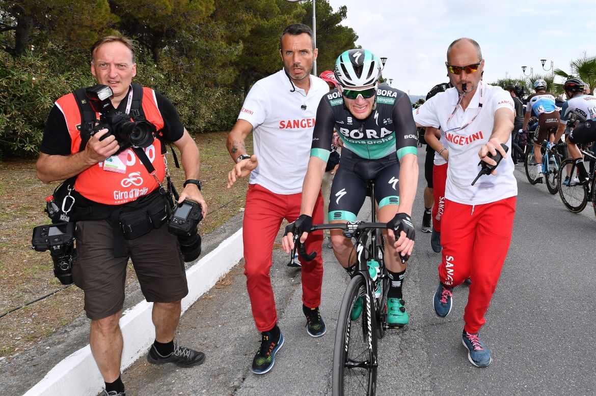 Sam Bennett is shepherded towards the podium