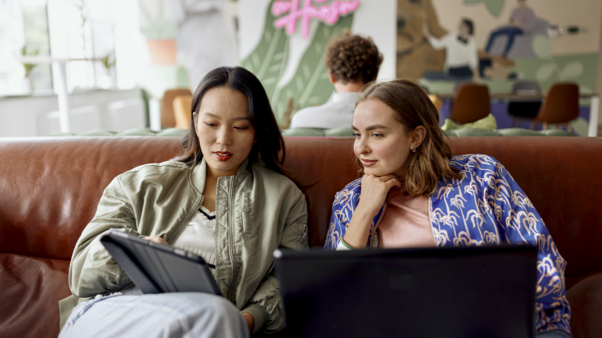 Two women working together and looking at a tablet computer