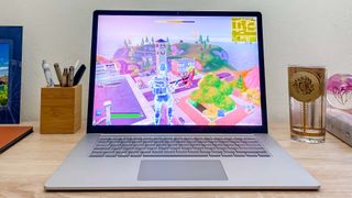 Surface Laptop 5 on desk with Fortnite playing on-screen