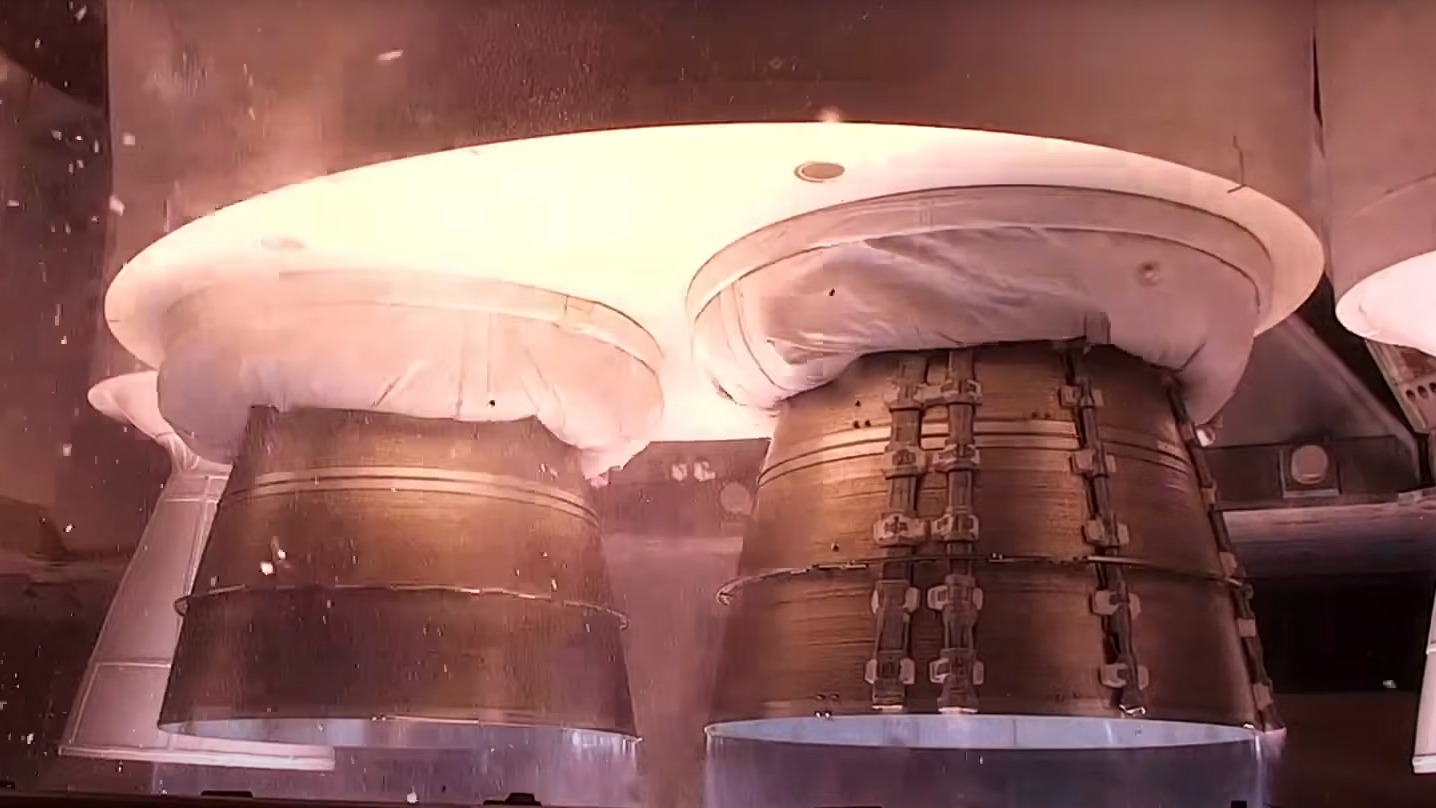 close up view of rocket shortly before liftoff with the engines ignited.