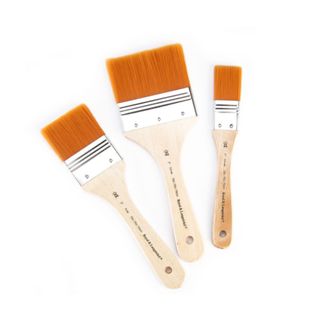 Three wide paint brushes with orange bristles and light wooden handles - one medium sized, one large, and one small