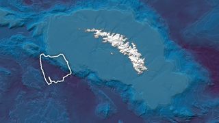 satellite photo showing a large iceberg aground on the edge of a small, icy island