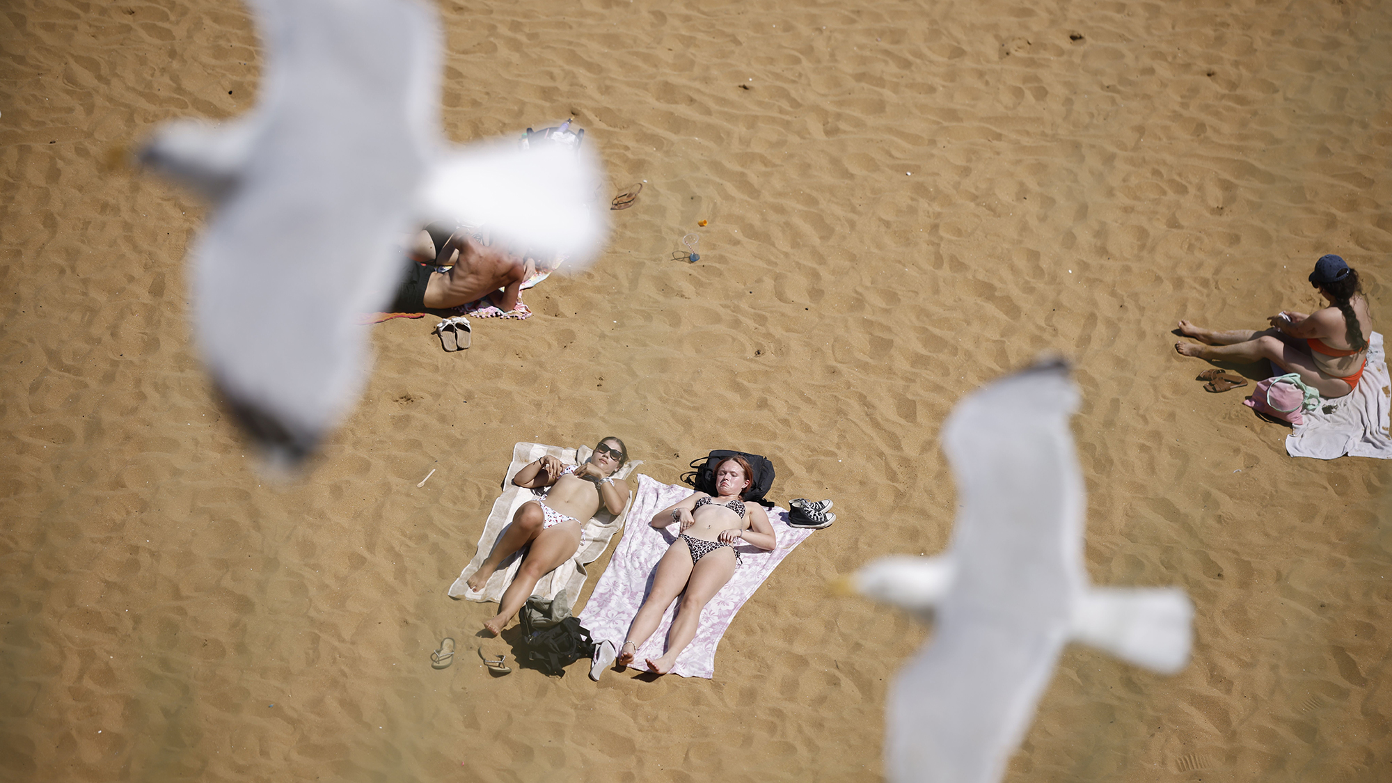 People sunbathe during a record-breaking heatwave at Viking Bay in Broadstairs, United Kingdom
