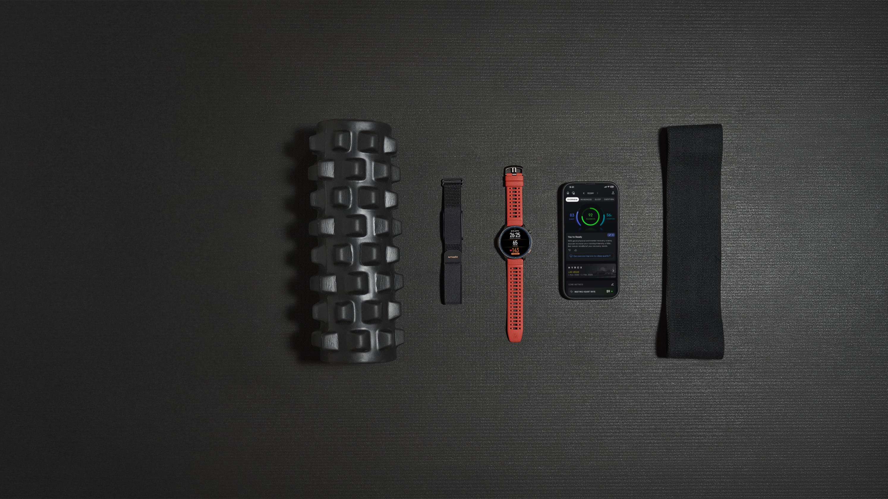 The Amazfit Balance 2 smartwatch and the Helio Strap laid out with phone and foam roller