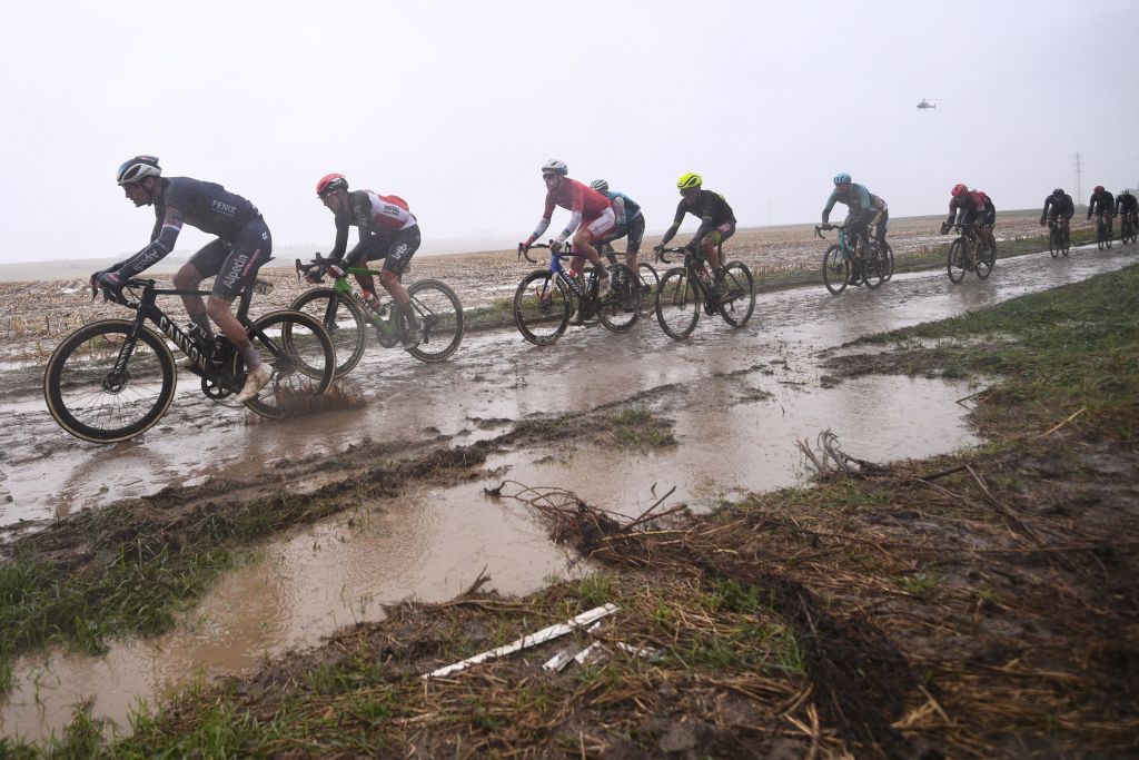 Alpecin Fenix Mathieu Van Der Poel from Netherlands L and the pack ride during the 118th edition of the ParisRoubaix oneday classic cycling race between Compiegne and Roubaix northern France on October 3 2021 Photo by AnneChristine POUJOULAT AFP Photo by ANNECHRISTINE POUJOULATAFP via Getty Images