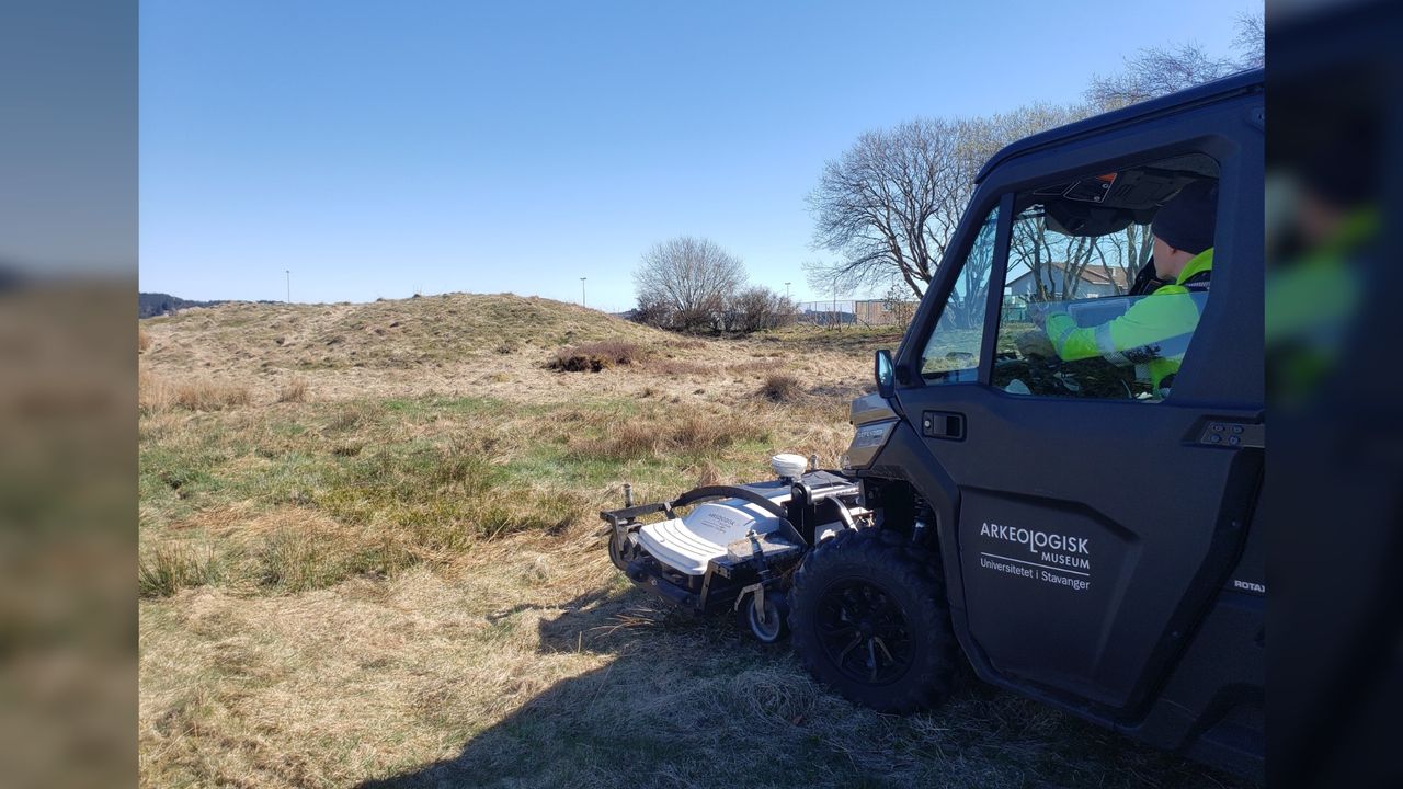 Archaeologists say the mounds above the ship burials would have been visible from ships at sea when they were relatively new during the Viking Age. This photo shows a large blue vehicle with an attachment on the front as it scans a grassy mound.