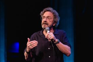 marc maron talks on stage at a wtf podcast event