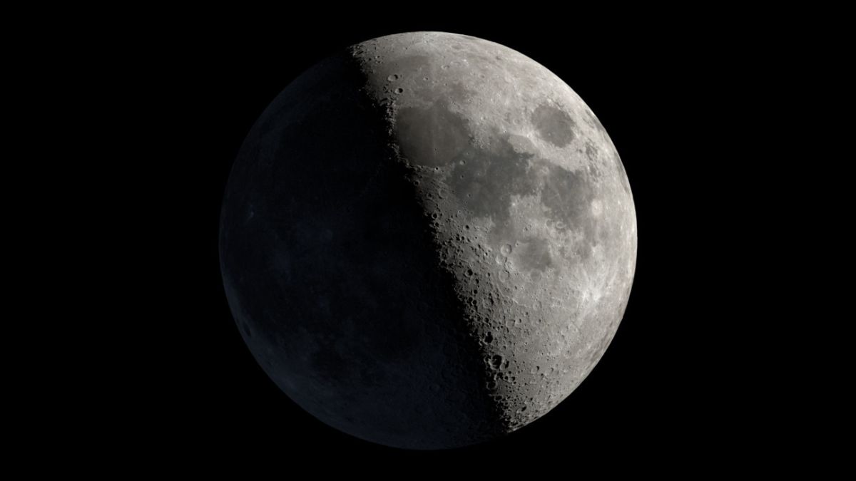 An image of Earth's moon at first quarter phase, with the right half of its disk lit by direct sunlight.