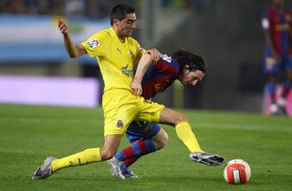 Villarreal's Bruno Soriano competes for the ball with Barcelona's Lionel Messi in 2007.
