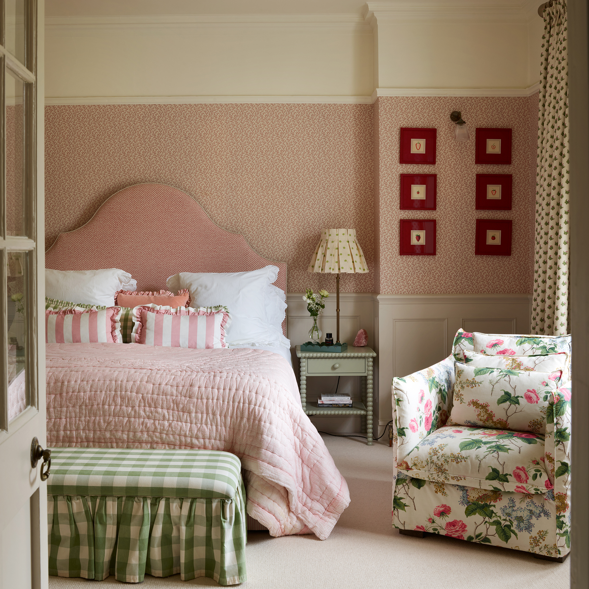 pink and green traditional style bedroom with a mix of floral, striped and check fabrics