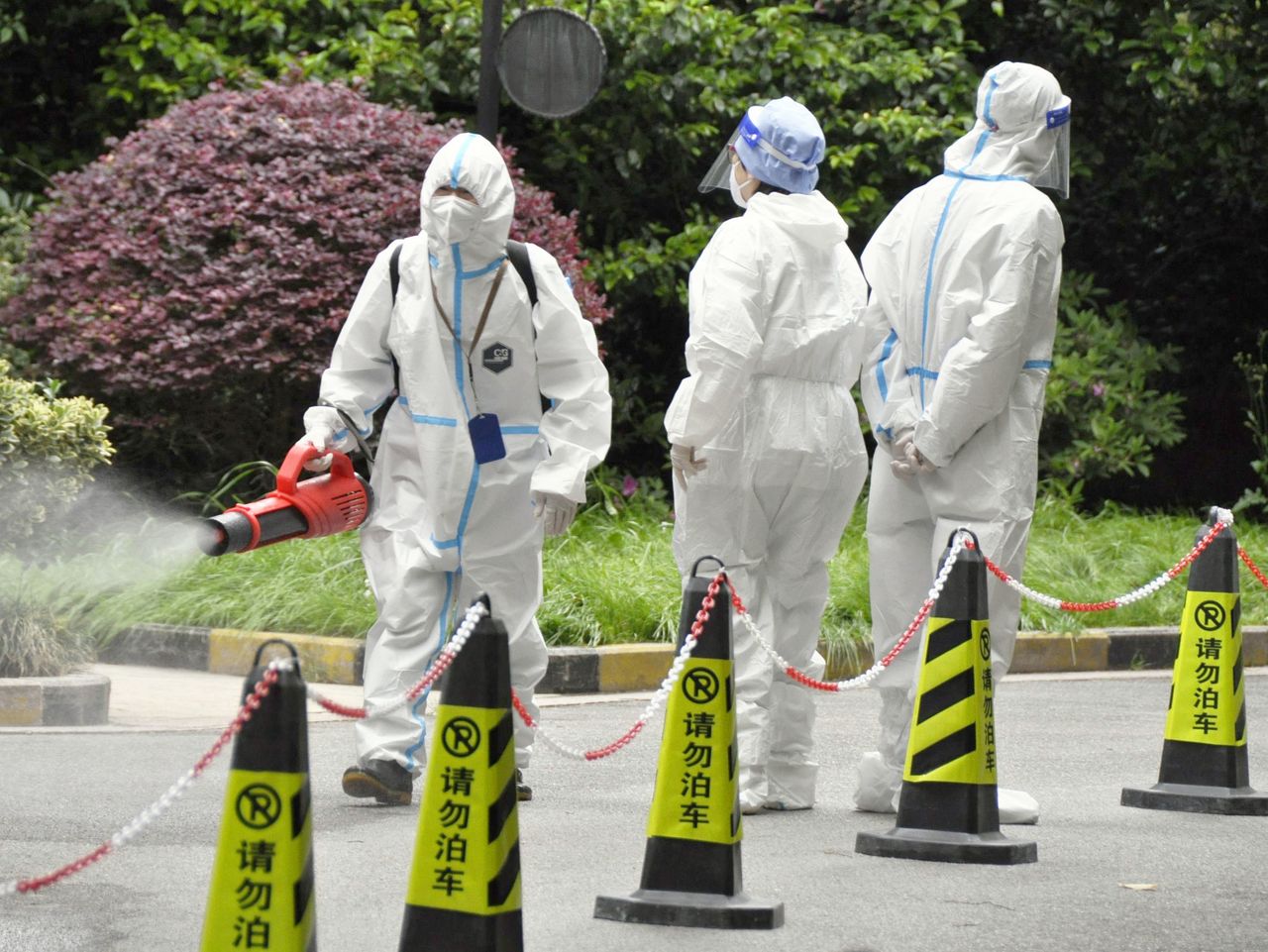 A group of workers in protective suits against COVID-19 in China. 