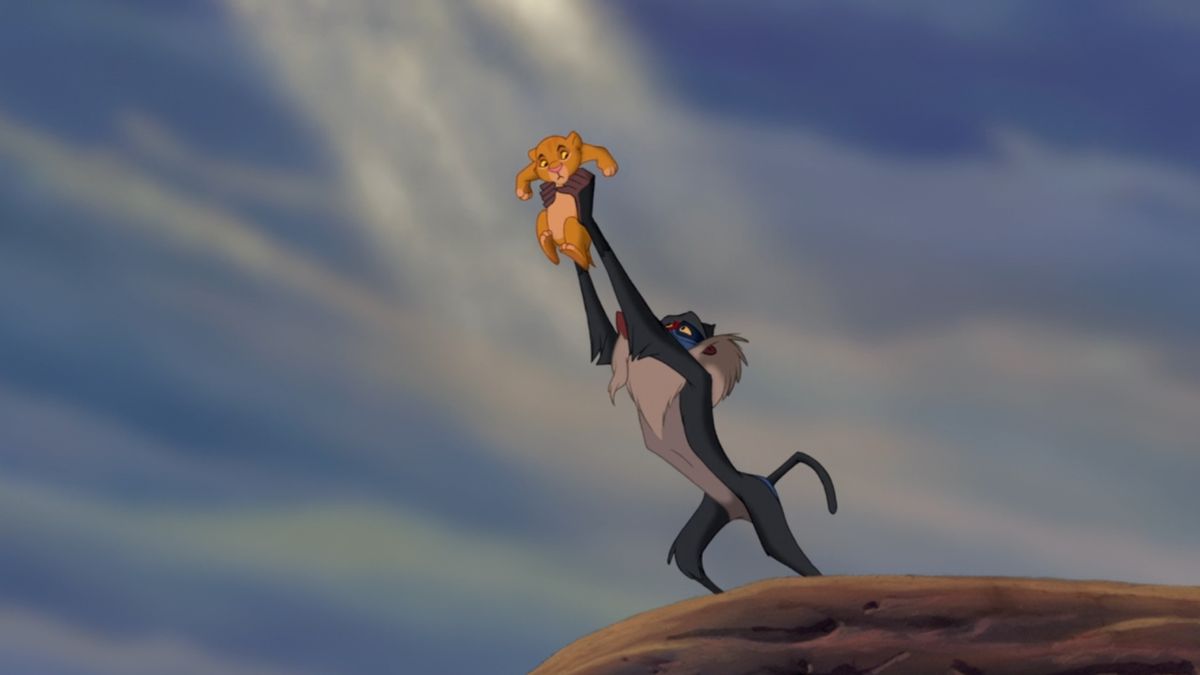 Rafiki holding up baby Simba