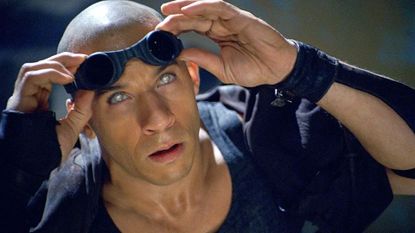 Riddick screengrab from Netflix, showing Vin Diesel putting on dark goggles