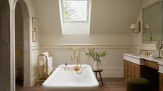 large traditional bathroom with a freestanding bath in the center and two arched alcoves