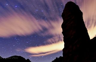 A Quadrantid meteor is seen streaking across a cloud-spattered sky with shadowy rocks in the foreground in this dazzling photo by astrophotographer Roberto Porto taken on Jan. 4, 2012 on Tenerife Island in Spain's Canary Islands during the meteor shower's