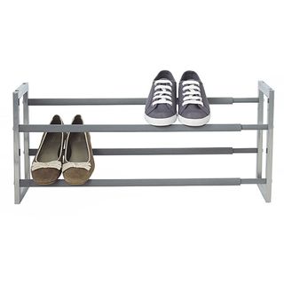 Extending Steel Shoe Rack with two pairs of shoes on it