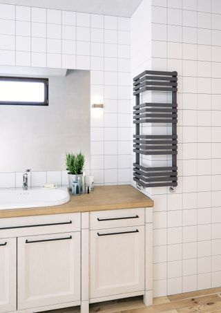 Corner radiator in bathroom by Frontline Bathrooms