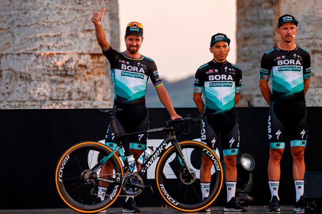 Team Bora rider Slovakias Peter Sagan L waves on stage at the Doric Temple of Segesta near Palermo Sicily on October 1 2020 during an opening ceremony of presentation of participating teams and riders two days ahead of the departure of the Giro dItalia 2020 cycling race Photo by Luca Bettini AFP Photo by LUCA BETTINIAFP via Getty Images