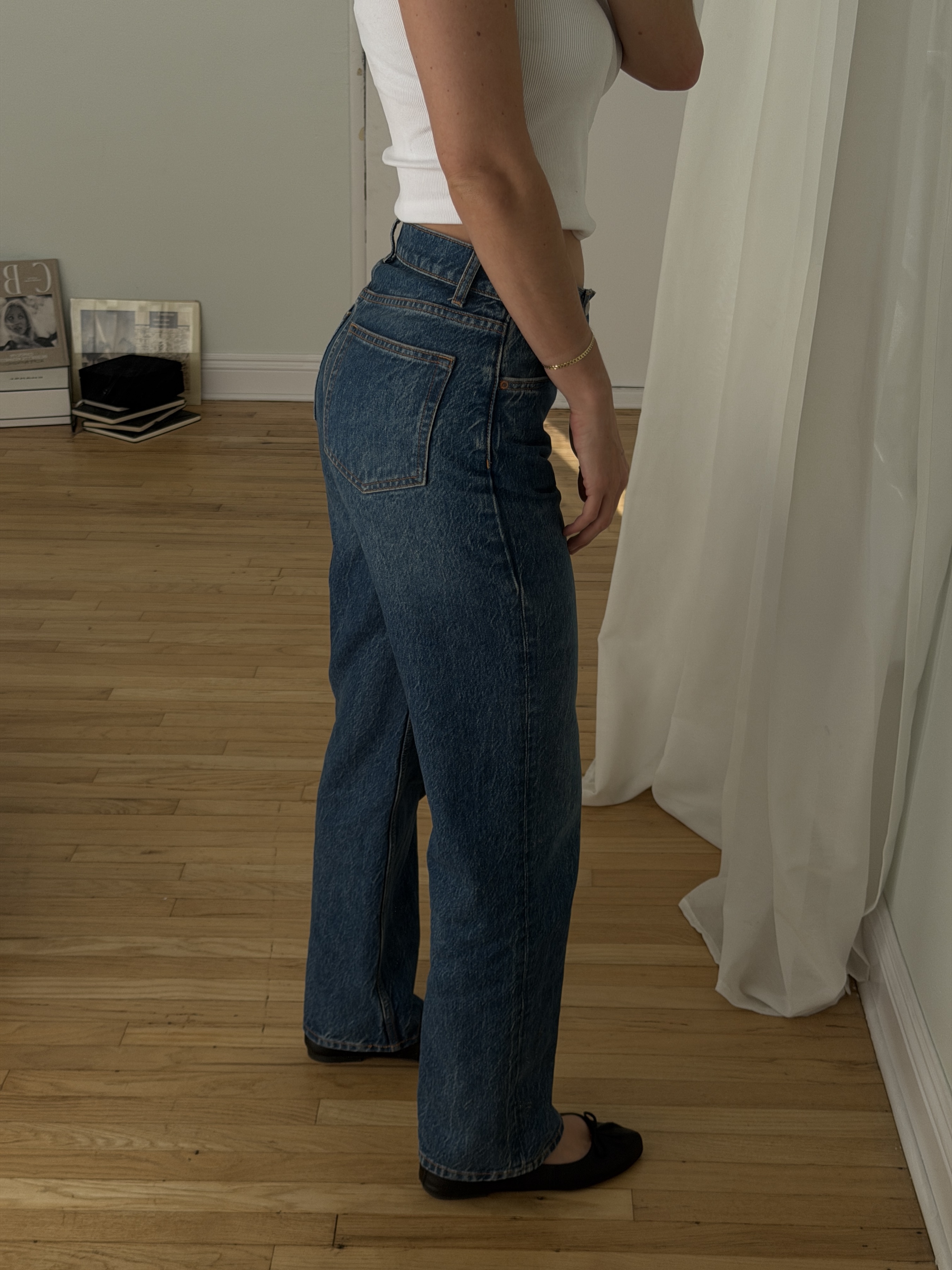 Kathryn Zahorak wearing white t-shirt, jeans, and ballet flats